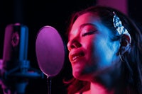 a woman singing into a microphone